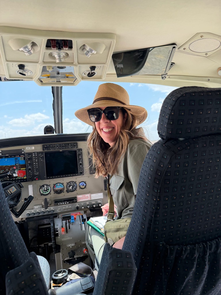 Traveler sitting in a small safari plane cockpit during a scenic flight over Kenya’s Maasai Mara